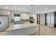 Bright, open kitchen with white cabinets, a large island, and stainless steel appliances at 14287 Rialto Ave, Brooksville, FL 34613