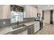 Stylish kitchen featuring granite countertops, stainless steel appliances, and white cabinetry at 14287 Rialto Ave, Brooksville, FL 34613