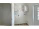 Bright laundry room with white cabinets, washer/dryer hookups, and access to a closet at 14287 Rialto Ave, Brooksville, FL 34613