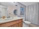 Clean bathroom with single sink vanity and linen closet at 155 Bluff View Dr # 103, Belleair Bluffs, FL 33770