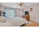 Bright bedroom with a double bed and wood dresser at 155 Bluff View Dr # 103, Belleair Bluffs, FL 33770