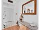 Bright condo entryway with tiled floors and a glass-top console table at 155 Bluff View Dr # 103, Belleair Bluffs, FL 33770