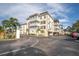 Two-story building exterior with balconies and landscaping at 155 Bluff View Dr # 103, Belleair Bluffs, FL 33770