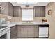 Efficient kitchen with wood cabinets and modern appliances at 155 Bluff View Dr # 103, Belleair Bluffs, FL 33770