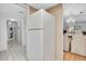 Kitchen area with white refrigerator and wood cabinets at 155 Bluff View Dr # 103, Belleair Bluffs, FL 33770