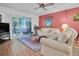 Bright living room with patio access and comfortable seating at 155 Bluff View Dr # 103, Belleair Bluffs, FL 33770