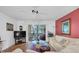 Living room with access to a screened balcony and hardwood floors at 155 Bluff View Dr # 103, Belleair Bluffs, FL 33770