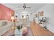 Living room with light beige sofas, hardwood floors, and a ceiling fan at 155 Bluff View Dr # 103, Belleair Bluffs, FL 33770