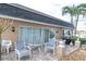 Outdoor patio area with seating and a grill at 155 Bluff View Dr # 103, Belleair Bluffs, FL 33770