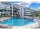 Community pool with surrounding patio at 155 Bluff View Dr # 103, Belleair Bluffs, FL 33770