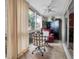 Bright sunroom with seating and glass doors at 155 Bluff View Dr # 103, Belleair Bluffs, FL 33770