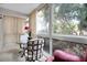 Sunroom with glass doors and outdoor view at 155 Bluff View Dr # 103, Belleair Bluffs, FL 33770