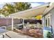 Covered wooden deck in backyard with seating, overlooking a fenced yard at 15950 Adobe Dr, Hudson, FL 34667