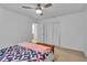 Bedroom featuring wood-look floors, ceiling fan, and closet doors at 15950 Adobe Dr, Hudson, FL 34667