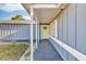 Welcoming covered front porch entryway, leading to a light yellow front door at 15950 Adobe Dr, Hudson, FL 34667