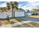 Front view of a single-story home with a driveway, garage, and fenced yard at 15950 Adobe Dr, Hudson, FL 34667