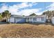 Front exterior view of a single-story home with a large front yard and attached garage at 15950 Adobe Dr, Hudson, FL 34667