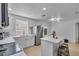 Bright, updated kitchen with white cabinets, stainless steel appliances, and an island at 15950 Adobe Dr, Hudson, FL 34667