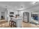 Modern white kitchen with island, stainless steel appliances, and wood-look flooring at 15950 Adobe Dr, Hudson, FL 34667