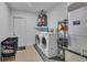 Laundry room with washer, dryer, and storage shelves at 15950 Adobe Dr, Hudson, FL 34667