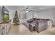 Spacious living room with wood floors, large TV, decorated Christmas tree, and ample seating at 15950 Adobe Dr, Hudson, FL 34667