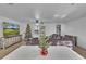 Cozy living room with a large TV, comfortable sectional sofa, and festive holiday decor at 15950 Adobe Dr, Hudson, FL 34667