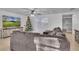 Living room with large TV, Christmas tree, sectional couch, and wood floors at 15950 Adobe Dr, Hudson, FL 34667