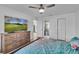 Spacious main bedroom with ensuite bathroom, wood floors, and a ceiling fan at 15950 Adobe Dr, Hudson, FL 34667