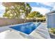 A fenced-in backyard with an inground pool and a covered patio at 15950 Adobe Dr, Hudson, FL 34667