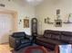 Living room with leather seating and grandfather clock and vaulted ceiling at 21107 Fountain View Ln # 5304, Lutz, FL 33558