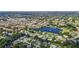 Scenic aerial view of a residential community with a lake, lush trees, and homes at 2118 Huntington Ave, Sarasota, FL 34232