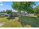 Spacious backyard with screened-in pool, lush lawn, and mature trees at 2118 Huntington Ave, Sarasota, FL 34232
