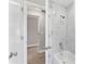 View of a bathroom shower with marble tile and updated fixtures at 2118 Huntington Ave, Sarasota, FL 34232