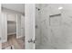 Modern bathroom shower with marble tile and updated fixtures at 2118 Huntington Ave, Sarasota, FL 34232