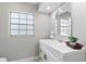 Clean and modern bathroom with white vanity, mirror, and window at 2118 Huntington Ave, Sarasota, FL 34232