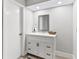 Updated bathroom with white vanity, mirror, and modern fixtures at 2118 Huntington Ave, Sarasota, FL 34232