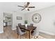 Dining room with wood-look flooring, ceiling fan, and adjacent kitchen at 2118 Huntington Ave, Sarasota, FL 34232