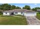 Charming single-story home with white siding, attached garage, and a landscaped front yard at 2118 Huntington Ave, Sarasota, FL 34232