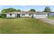 Charming single-story home with white exterior, attached garage, and manicured lawn at 2118 Huntington Ave, Sarasota, FL 34232