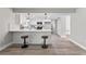 Modern white kitchen with quartz countertops and breakfast bar at 2118 Huntington Ave, Sarasota, FL 34232