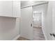 Laundry room with white cabinets and sliding barn door at 2118 Huntington Ave, Sarasota, FL 34232