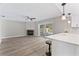 Living area with fireplace, updated flooring, and open view to the pool at 2118 Huntington Ave, Sarasota, FL 34232