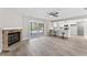 Open living room with fireplace, wood-look floors, and view of the pool at 2118 Huntington Ave, Sarasota, FL 34232