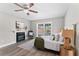 Cozy main bedroom with fireplace, wood-look floors, and backyard access at 2118 Huntington Ave, Sarasota, FL 34232