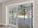 View of screened-in pool through French doors at 2118 Huntington Ave, Sarasota, FL 34232