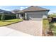 A paved driveway leads to a two-car garage with a well-maintained lawn and landscaping at 3208 Heart Pine Ave, Odessa, FL 33556