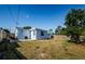 Wide view of a large backyard featuring a patio, green space, and a partial fence at 3444 Clydesdale Dr, Holiday, FL 34691