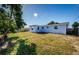 Large, fenced backyard with a grassy lawn and a small tree at 3444 Clydesdale Dr, Holiday, FL 34691