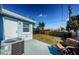 Backyard featuring a partially fenced yard, patio, and mature landscaping at 3444 Clydesdale Dr, Holiday, FL 34691