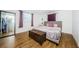 Comfortable bedroom featuring hardwood floors, a large window, and a queen size bed at 3444 Clydesdale Dr, Holiday, FL 34691